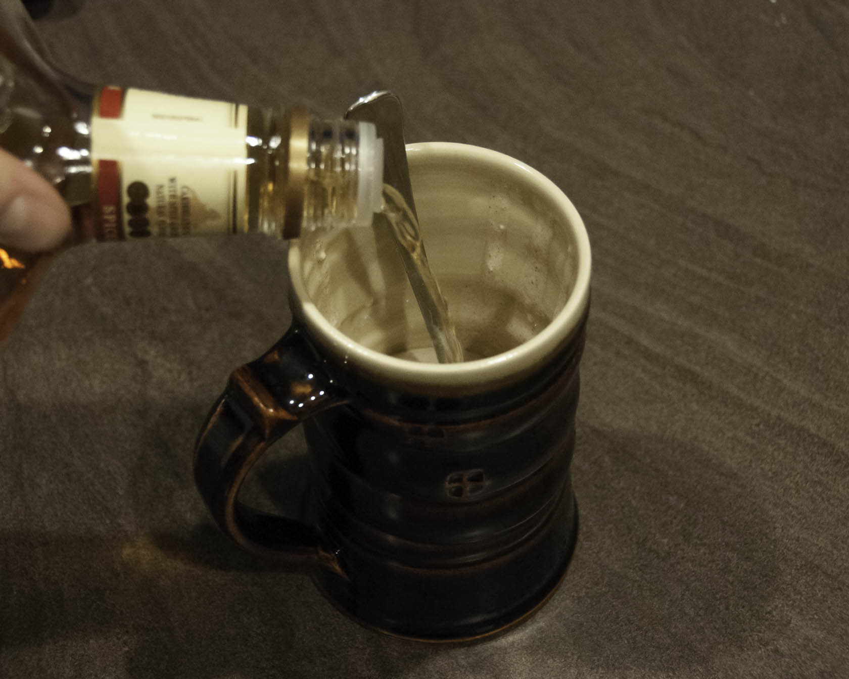 Adding rum to mug